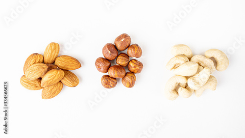Peeled almonds, hazelnuts and cashew nuts close-up. Macro photo of nuts. The concept of healthy food, vegetarianism. Banner 16:9.