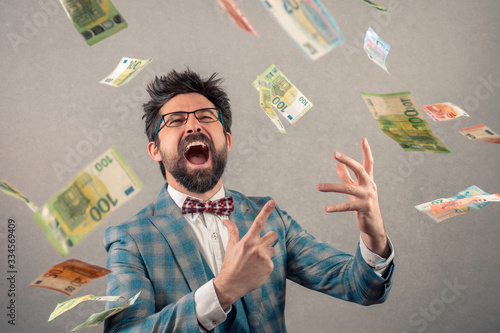 Happy business man with glasses and money flying