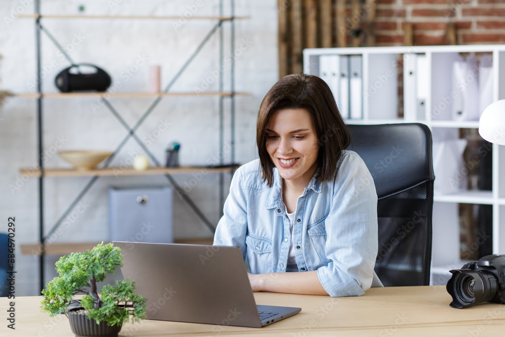 Working from home.Communication online with colleagues and freelancers and video conference. Portrait of smiling female freelancer using laptop for a online meeting in video call. Working from home.Communication online with colleagues and freelancers and video conference. Portrait of smiling female freelancer using laptop for a online meeting in video call.