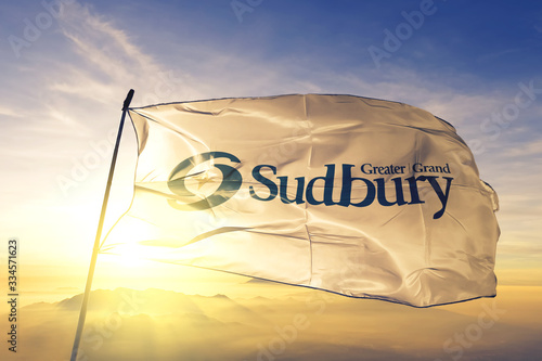 Greater Sudbury of Ontario of Canada flag waving on the top sunrise mist fog photo