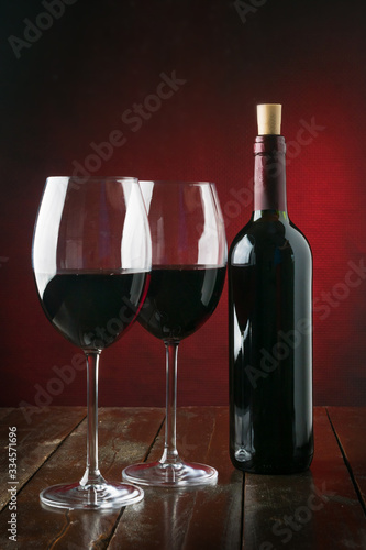 Bottle and glasses with red wine