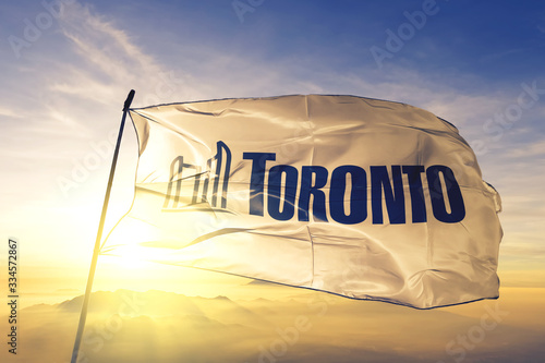 Photography Toronto of Ontario of Canada flag waving on the top sunrise mist fog