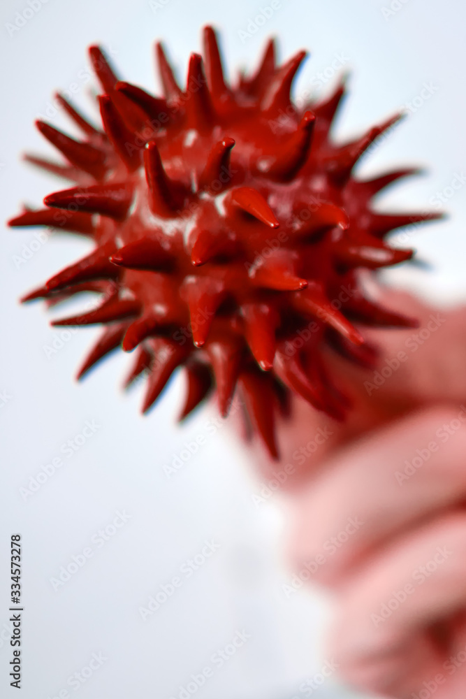 Red molecule of the flu virus in the hands of a medic on a white background, concept Red molecule of the flu virus in the hands of a medic on a white background, concept