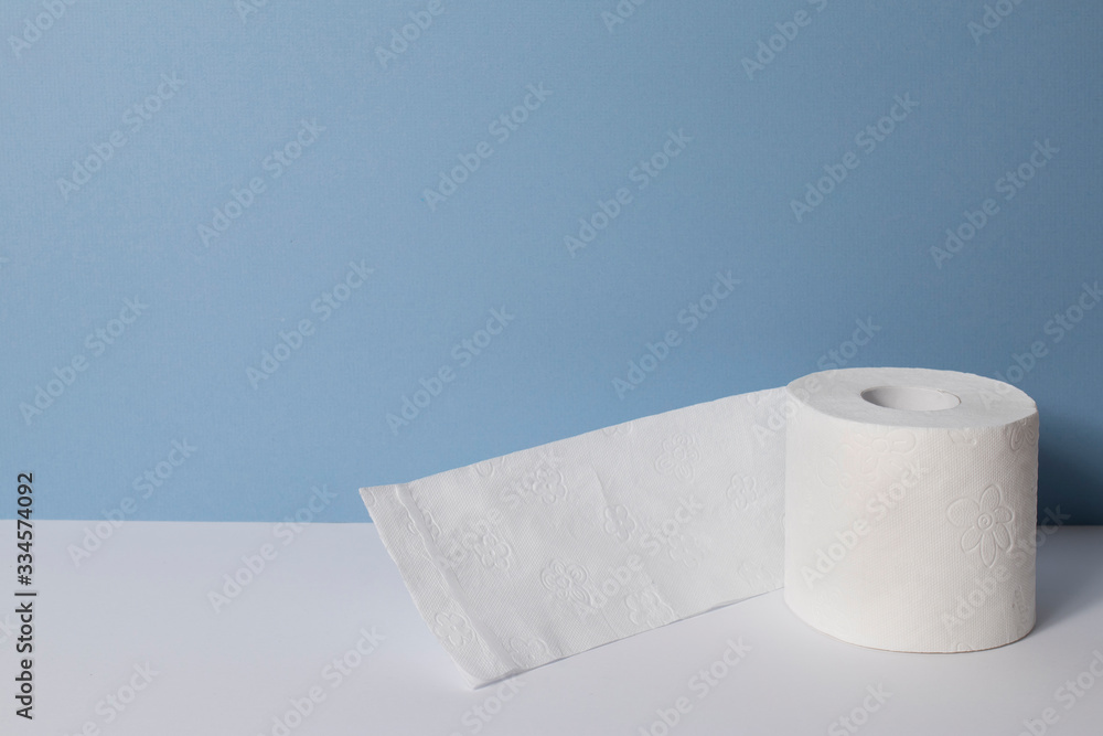 Roll of toilet paper on a blue background. Roll of toilet paper on a blue background.