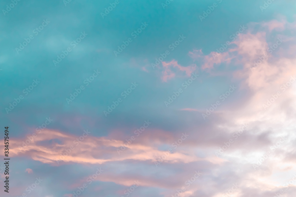 Sunset in Russia in spring. Beautiful light pink clouds on a blue sky. Background. Copy space.