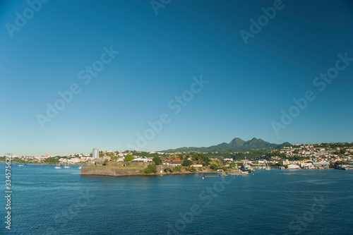 Fototapeta Naklejka Na Ścianę i Meble -  Distant Caribbean Island port from a Cruise ship