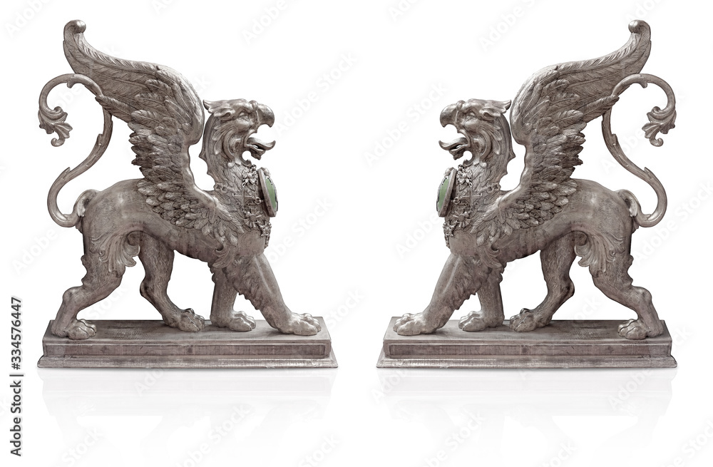 Silver decorative elements in the form of an ancient mythological monster griffin isolated on white background Silver decorative elements in the form of an ancient mythological monster griffin isolated on white background