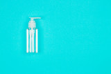 Hand alcohol sanitizer gel on blue background. Coronavirus protection. Top view. Flat lay.