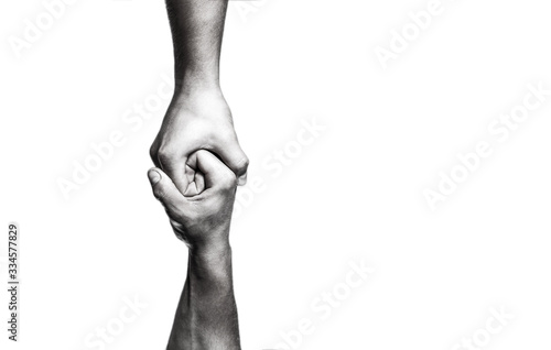 Helping hand concept and international day of peace, support. Helping hand outstretched, isolated arm, salvation. Close up help hand. Two hands, helping arm of a friend, teamwork. Black and white photo