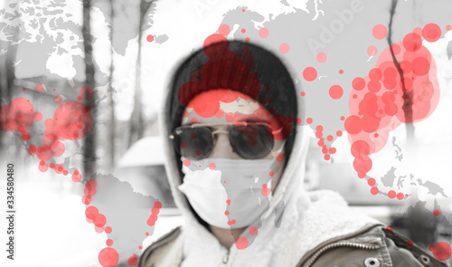 Portrait of a citizen with the protective mask and glasses and a world map with corona virus covid-19 infection points