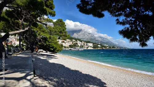 BRELA, CROATIA - MAY 3, 2019 - The boardwalk in the harbor at Brela. The Makarska riviera in Croatia is famous for its beautiful pebbly beaches and crystal clear water.