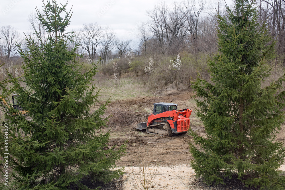 Bobcat Removing Rubbish from Field Bobcat Removing Rubbish from Field