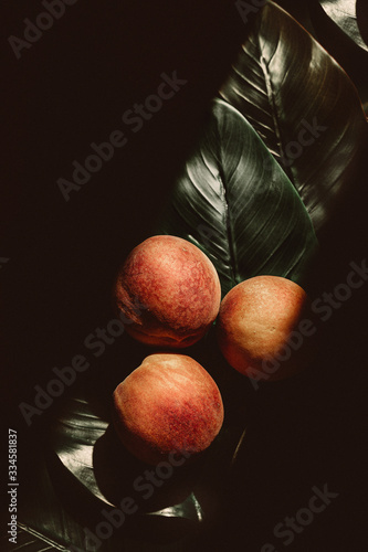 Overhead view of peaches on leaf