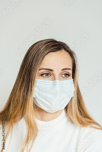 Anxious woman with face mask worried about the Covid-19 outbreak