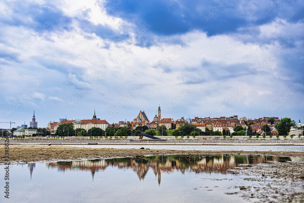 View on Warsaw City Center and Old Town from Vistula river with reflection in water at day. Poland, Europe