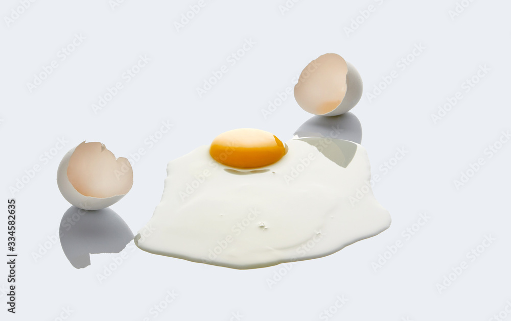 White broken chicken egg on a light background. White broken chicken egg on a light background.