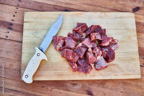 pork and knife lie on a wooden cutting board