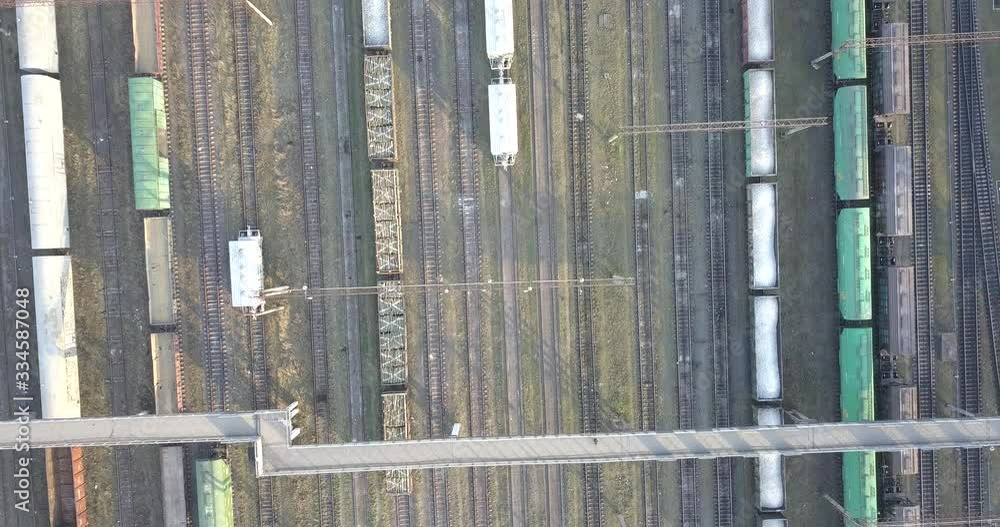 Cargo trains close-up. Aerial view of colorful freight trains on the railway station. Wagons with goods on railroad. Heavy industry. Industrial conceptual scene with trains. Top view from flying drone Cargo trains close-up. Aerial view of colorful freight trains on the railway station. Wagons with goods on railroad. Heavy industry. Industrial conceptual scene with trains. Top view from flying drone