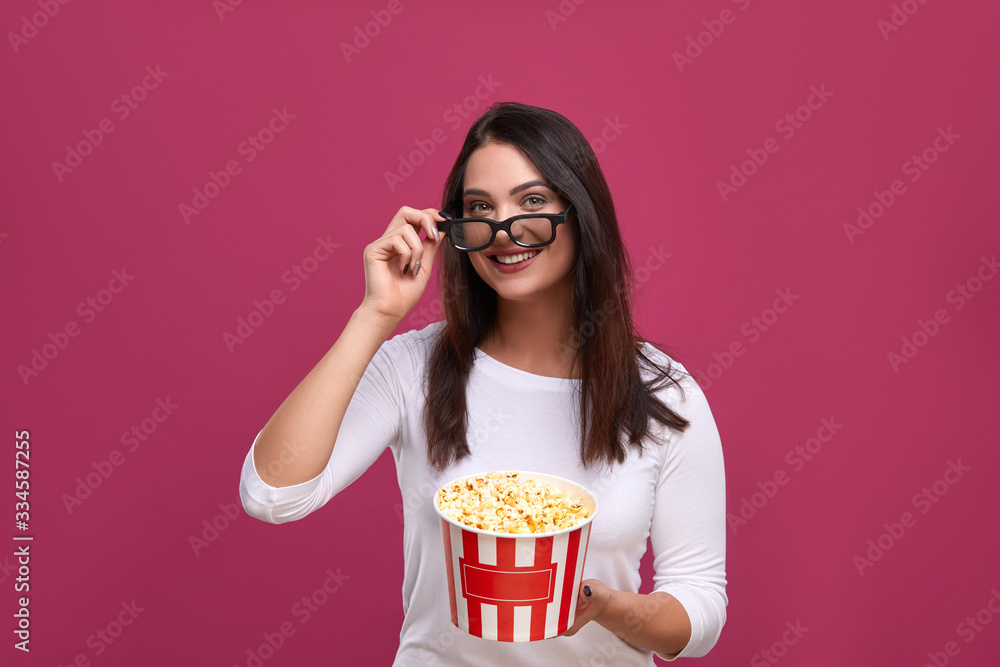 Positivity woman holding 3d glasses by hand at cinema.