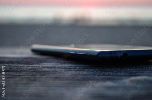 Phone on wooden desk in focus