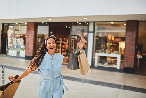 Portrait excited woman shopping in mall photo