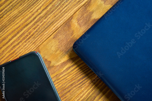 Laptop with smartphone. Worlplace on the wooden table. photo