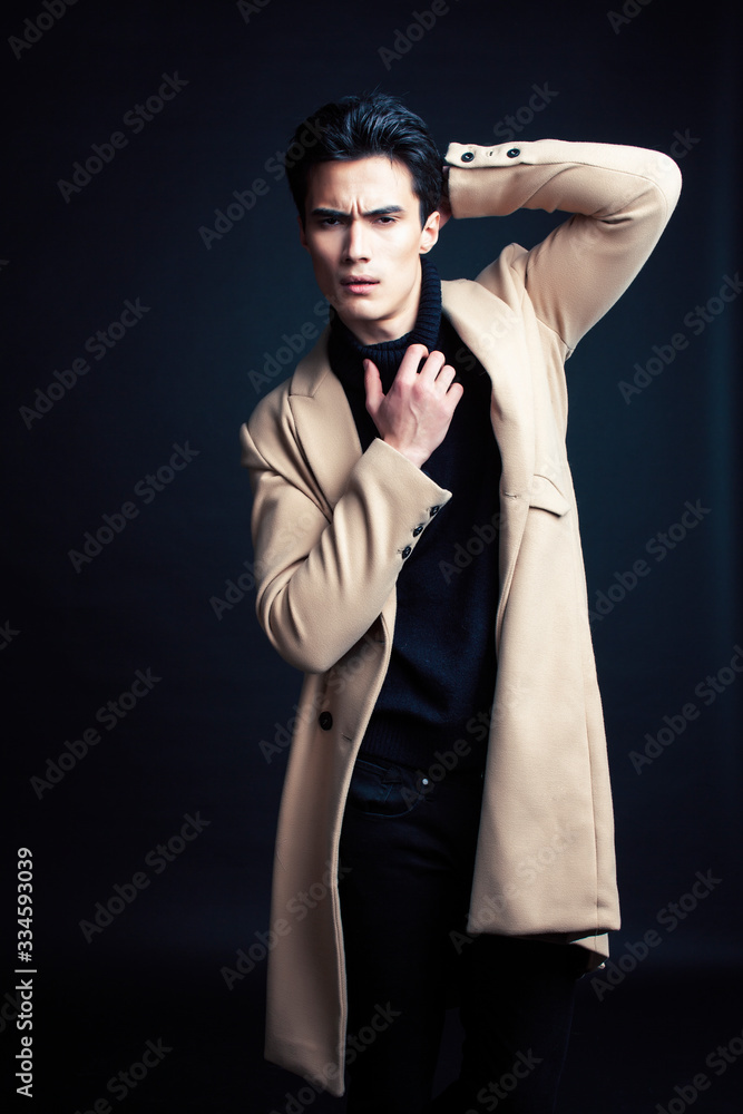 Obraz premium handsome asian fashion looking man posing in studio on black background, lifestyle modern people concept