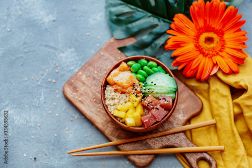 Raw Organic Ahi Tuna Poke Bowl with Rice and Veggies close-up on the table