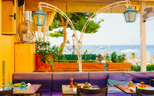 Fototapeta Naklejka Na Ścianę i Meble -  Terraced street cafe in Positano town on Amalfi Coast reflex