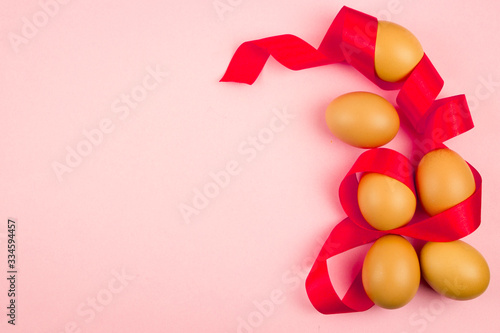 Eggs festively decorated lie on a simple background with place for text, top view, concept of Easter spring holiday