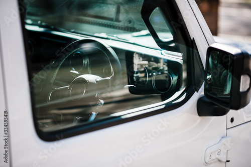 Side view of new SUV door with steering wheel interior and reflections © ifeelstock