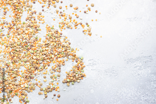 Flat lay composition with different types of grains and cereals on light grey concrete background. Food ingredients and agricultural product concept.