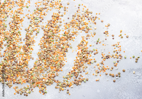 Flat lay composition with different types of grains and cereals on light grey concrete background. Food ingredients and agricultural product concept. © valentinamaslova