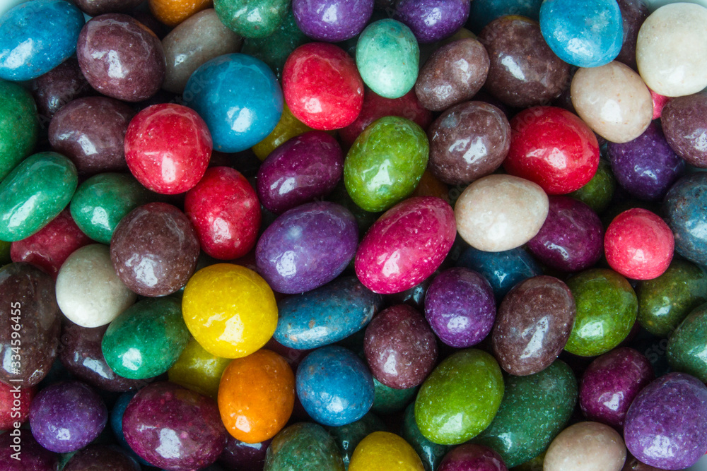 A scattering of candies in a multicolored glaze close up with copy space A scattering of candies in a multicolored glaze close up with copy space