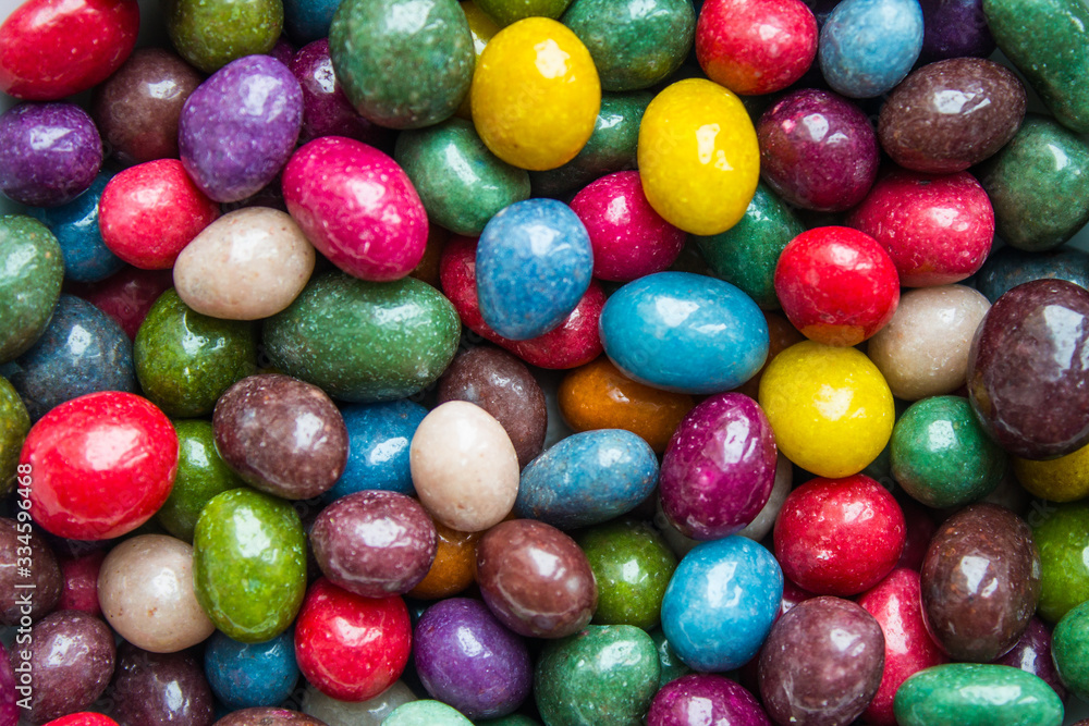 A scattering of candies in a multicolored glaze close up with copy space A scattering of candies in a multicolored glaze close up with copy space