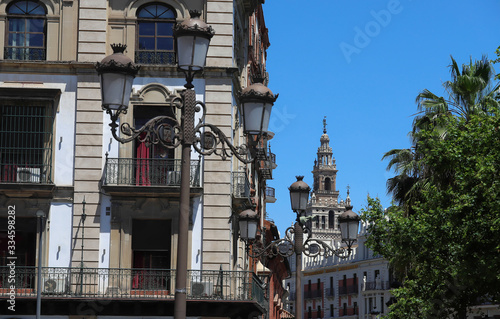 The Giralda, the bell tower of the Cathedral of Seville and traditional lamp post in the foregrond, Seville, Spain. photo