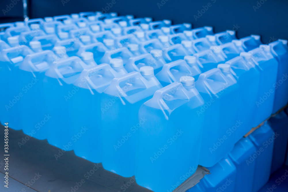Fototapeta premium Alcohol for cleaning and sanitizing is contained in gallons in the warehouse. Many gallon alcohol gel for sanitizing Coronavirus Covid-19. Products for sale to anti Coronavirus protection (Covid 19).