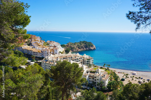 View to resort village and blue sea coastline from high