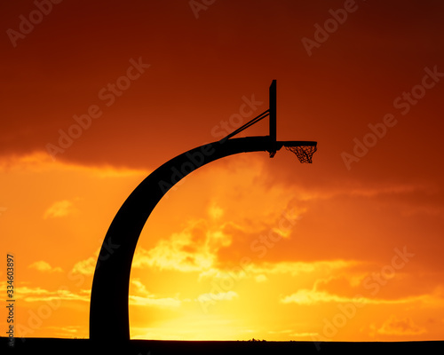 Sunset with basketball hoop photo
