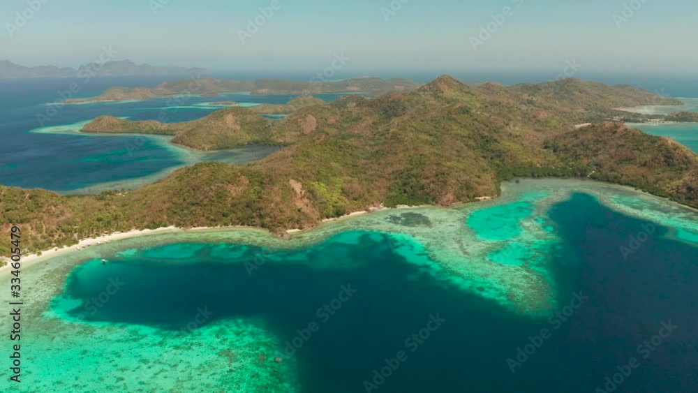 aerial view tropical island Bulalacao with blue lagoon, coral reef and sandy beach. Palawan, Philippines. Islands of the Malayan archipelago with turquoise lagoons. aerial view tropical island Bulalacao with blue lagoon, coral reef and sandy beach. Palawan, Philippines. Islands of the Malayan archipelago with turquoise lagoons.