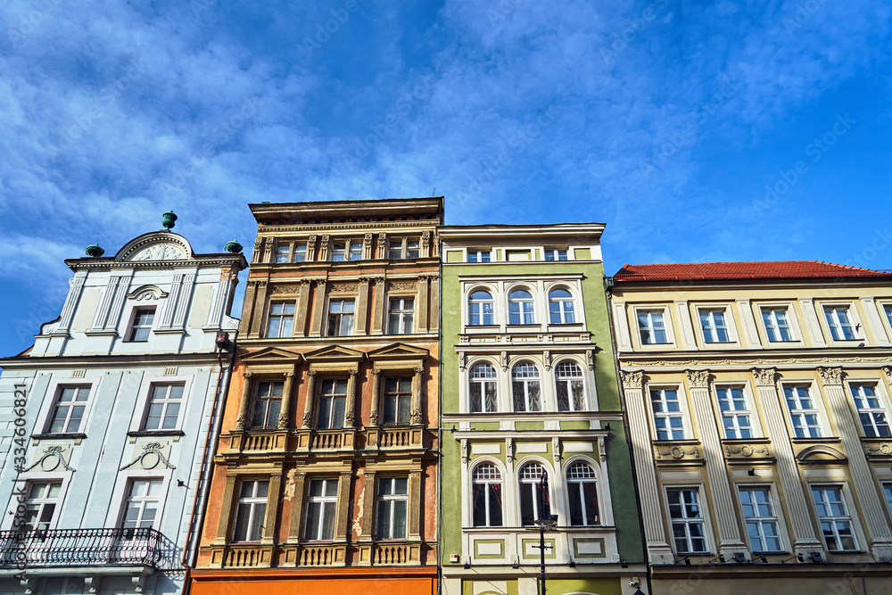 Facades of historic tenement houses on a sunny day in the city of Poznan..