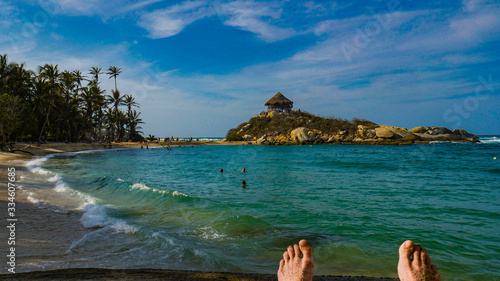 Amazing view of relaxing with feet up at caribbean beach with beautiful turquoise water and sunny day. Tayrona National Park in Colombia, South America. Cabo San Juan. © Douglas James Butner