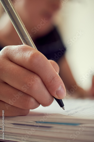 young woman working writing notes phone smile