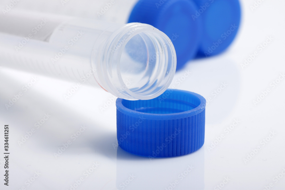 Close up shot of empty plastic test tube with blue lid for medical and laboratory testing purpose Close up shot of empty plastic test tube with blue lid for medical and laboratory testing purpose