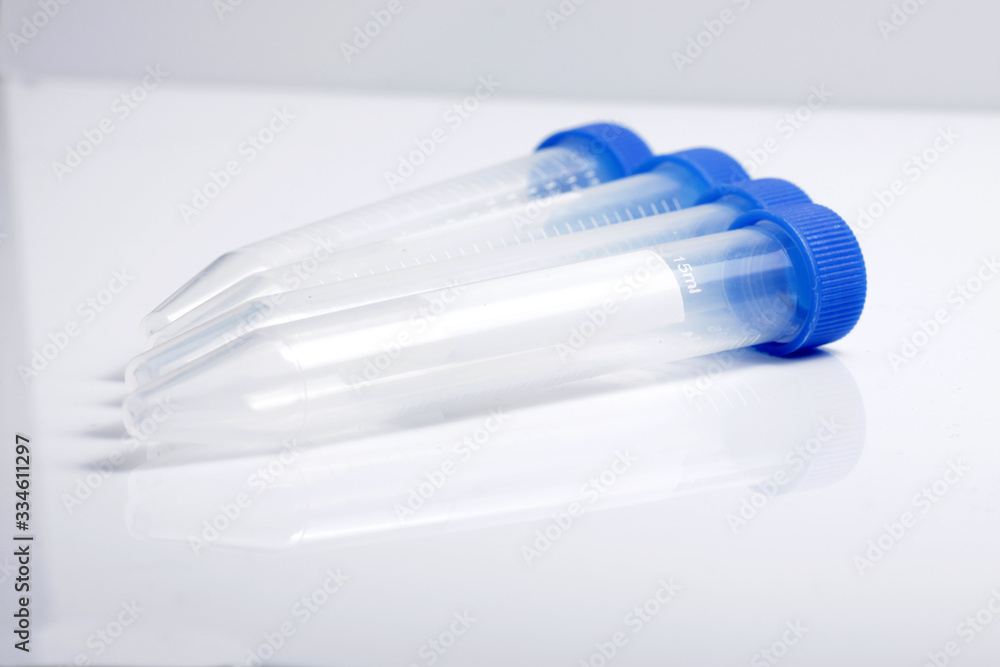 Close up shot of empty plastic test tube with blue lid for medical and laboratory testing purpose Close up shot of empty plastic test tube with blue lid for medical and laboratory testing purpose