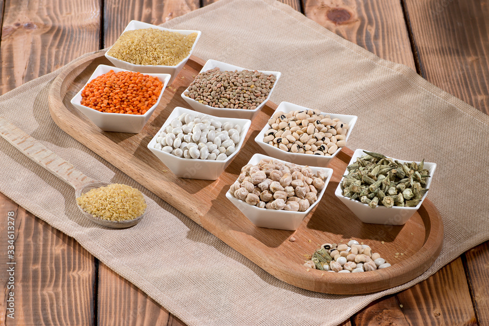 Various dried legumes on wooden board