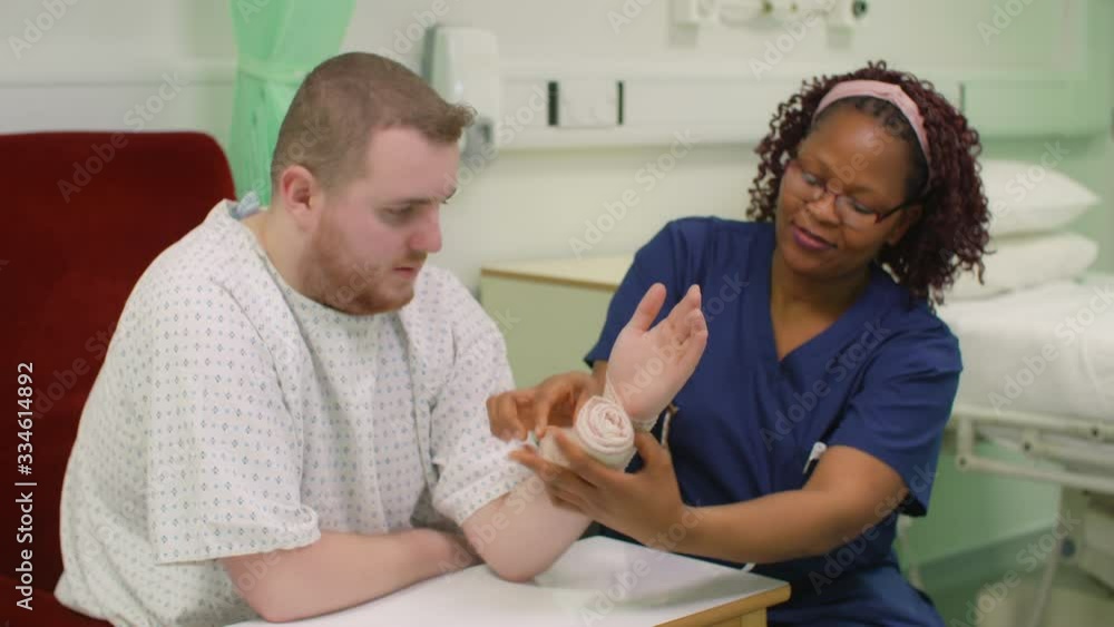 Nurse Starts Bandaging Patients Injured Wrist Nurse Starts Bandaging Patients Injured Wrist