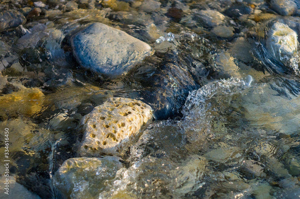 pebble stones on the sea beach, the rolling waves of the sea with foam pebble stones on the sea beach, the rolling waves of the sea with foam