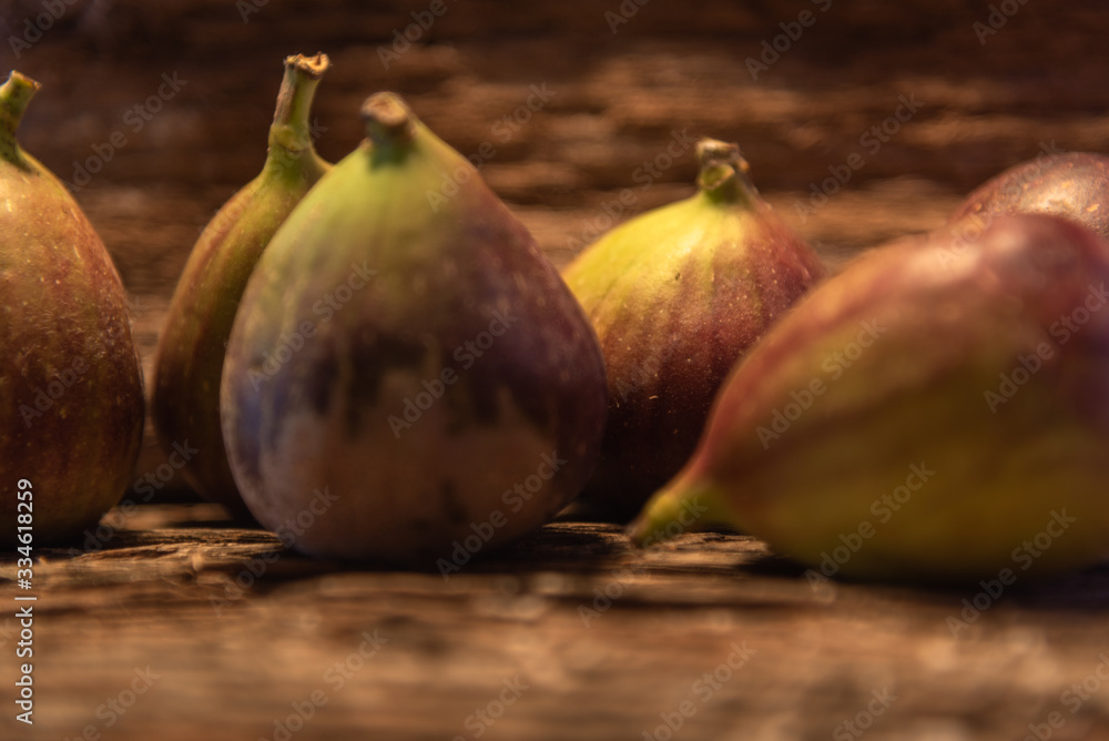 Fresh fig fruits (Ficus carica L.) with peel on a piece of aged wood