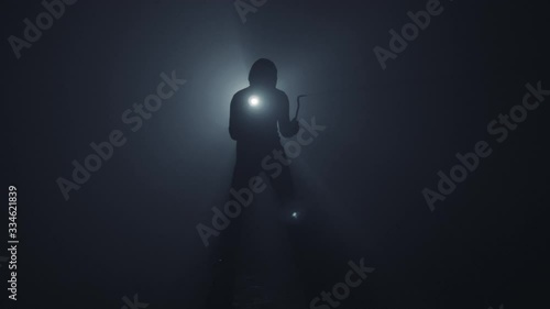 A thief with a flashlight and a crowbar